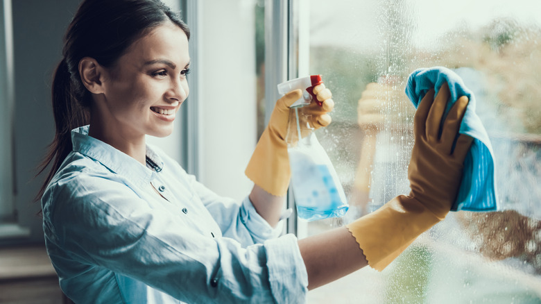 Woman cleaning a window