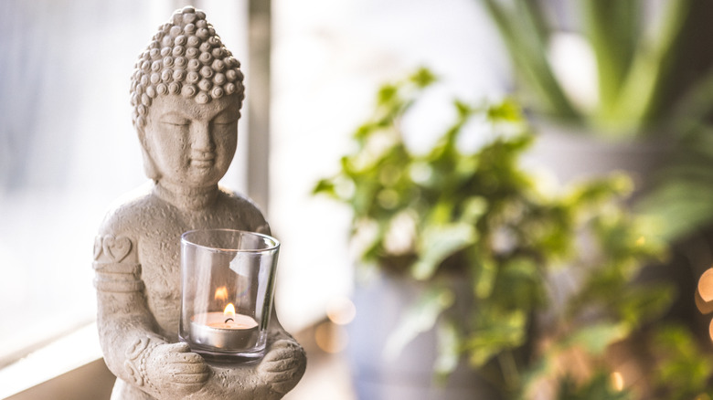 Buddha and plants in window