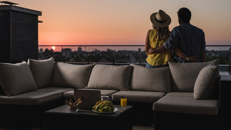 A couple leans on a modular patio set