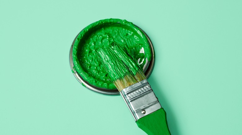 Green paint and paint brush