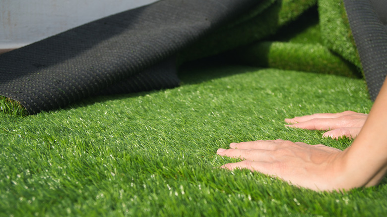 artificial turf lawn hands