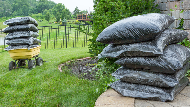 mulch bags stacked in yard