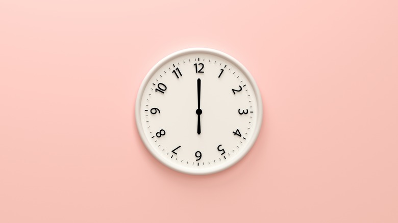 clock on pink wall