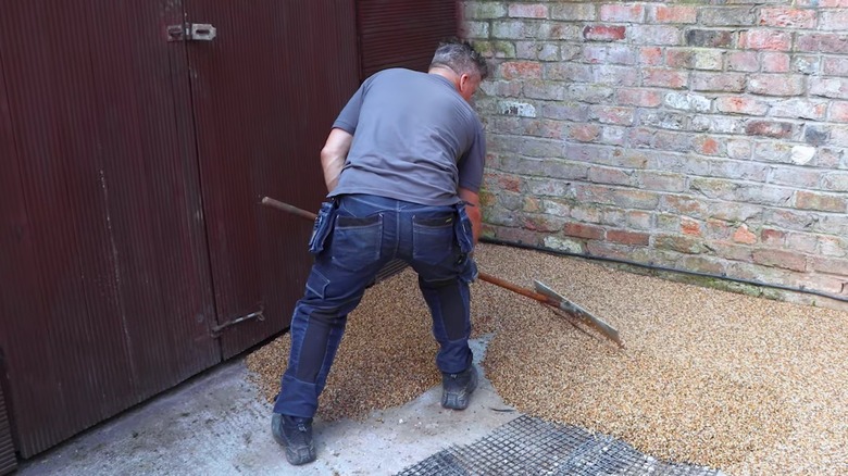 A worker installing resin bound gravel