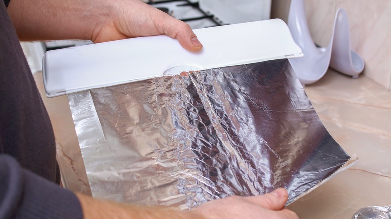 tearing off some aluminum foil