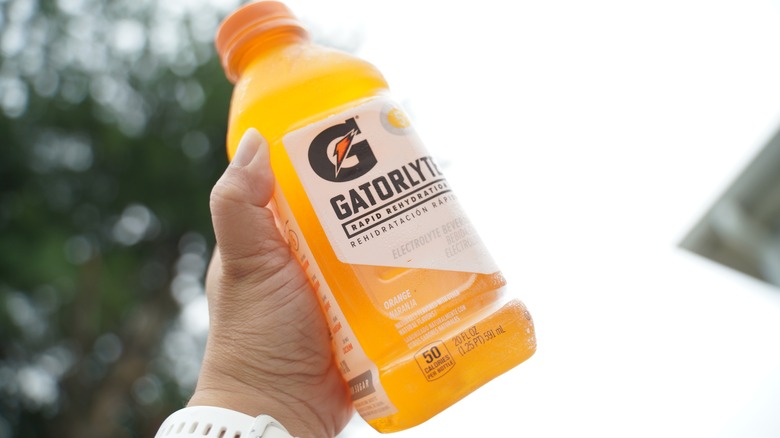 hand holding orange Gatorade bottle