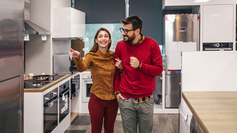 Couple choosing fridges