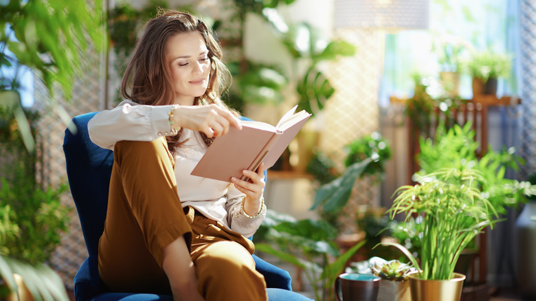 Person reading by plants