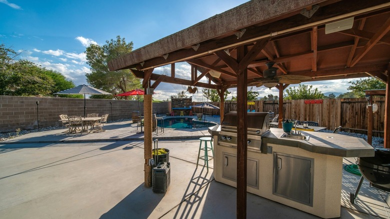 Patio area with kitchen and pool