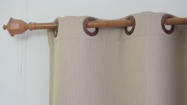 Beige curtain on wooden rod