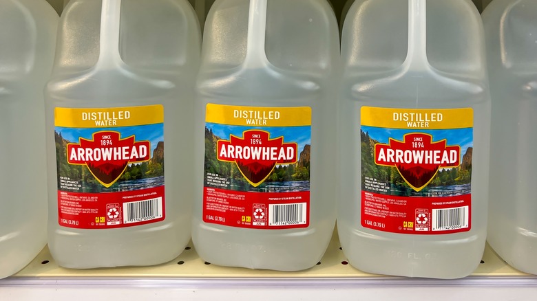 jugs of distilled water on shelf