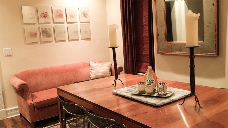 Pink couch in dining room