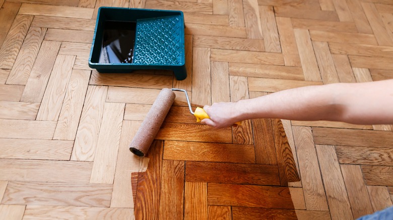 Person staining oak floors