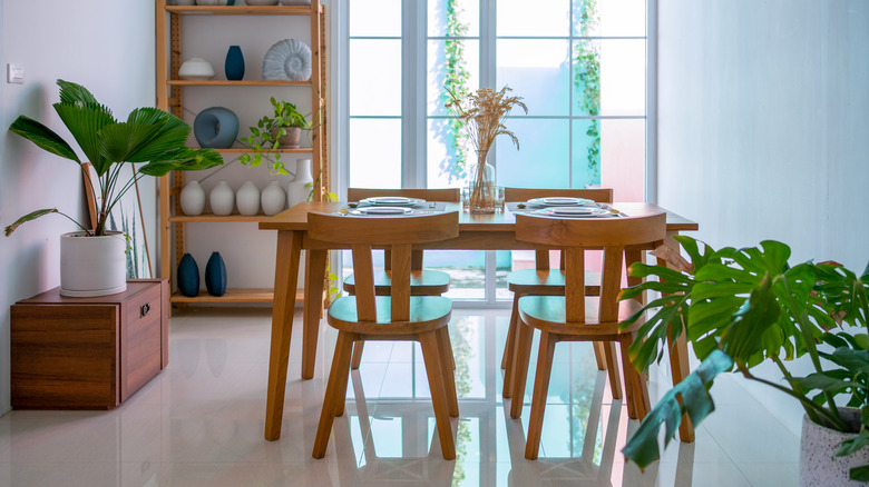 An elegant modern dining room which has a wooden table and wooden chairs.