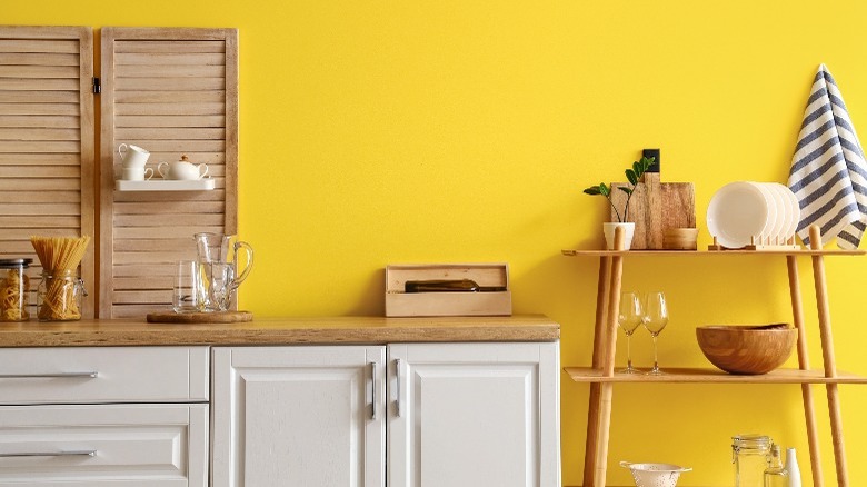 yellow wall with busy kitchen arrangement