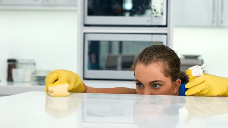 Woman inspecting counter spotless clean