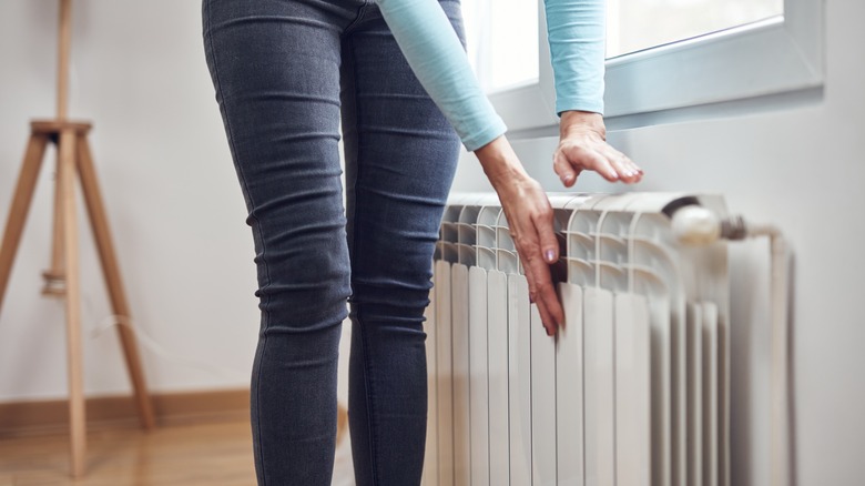 person touching radiator