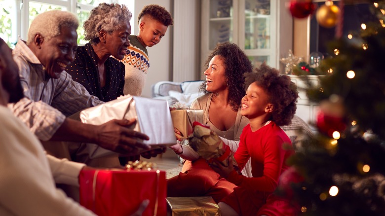 family exchanging christmas gifts