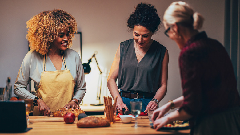 friends preparing food in kitchen