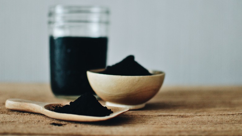 Activated charcoal in various containers
