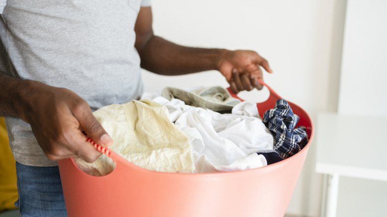 Person carrying a laundry basket