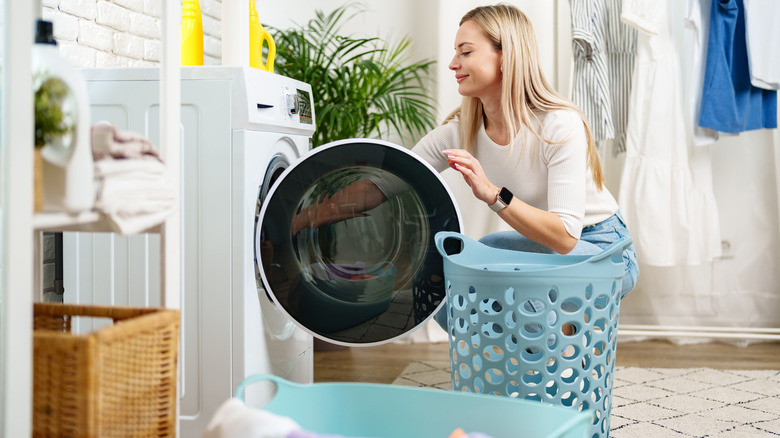 Woman doing laundry with laundry baskets