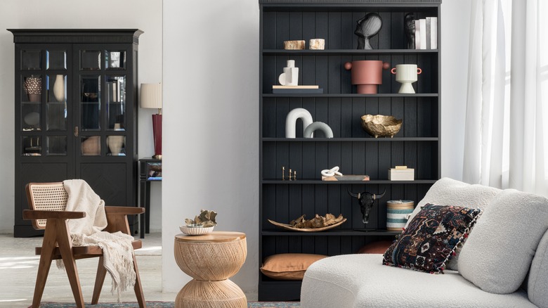 Living area with black bookcase and cabinet