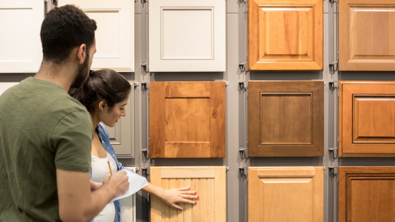 Couple looking at cabinet door samples in store