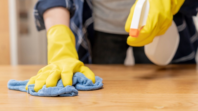 person using wood cleaner