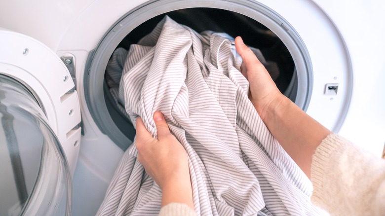 Woman using washing machine