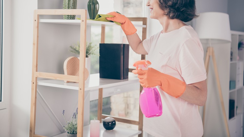 Woman wiping shelving