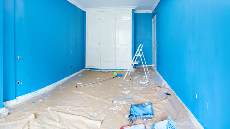 A blue room being prepped for painting 