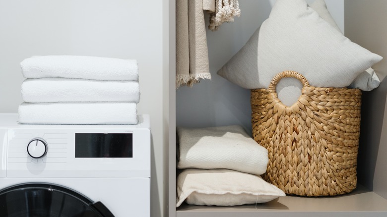 stack of pillows beside washing machine