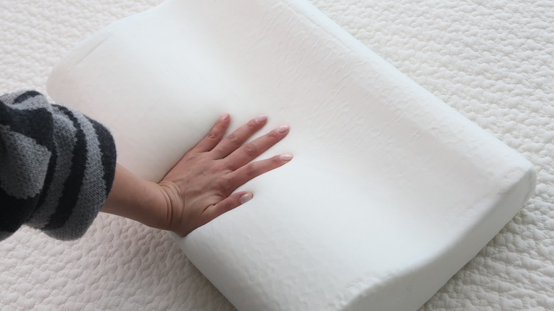 person testing out memory foam pillow