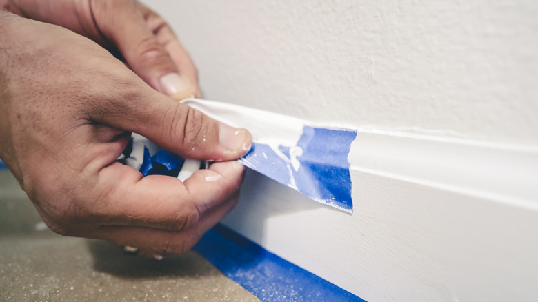 Person removing painter's tape