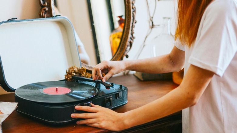 person playing record on turntable