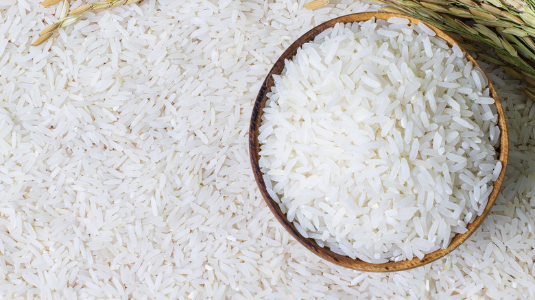 wooden bowl filled with uncooked rice