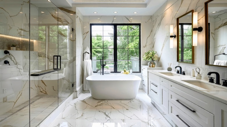 A spacious, modern bathroom with black and white color scheme