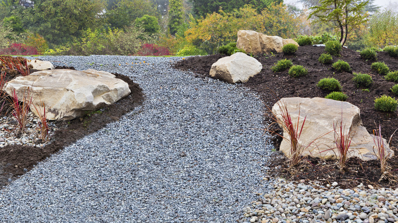 Path made from small gravel winding through rock and planting