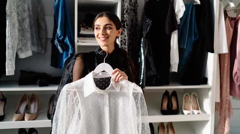 person standing in closet smiling