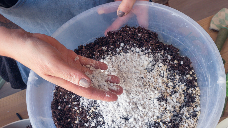 hands mixing soil ingredients