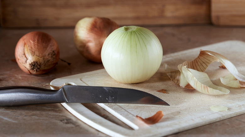 onions cutting board with knife