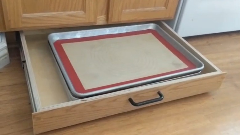 toe kick drawer holding sheet pans