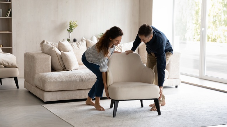 couple moving a new chair