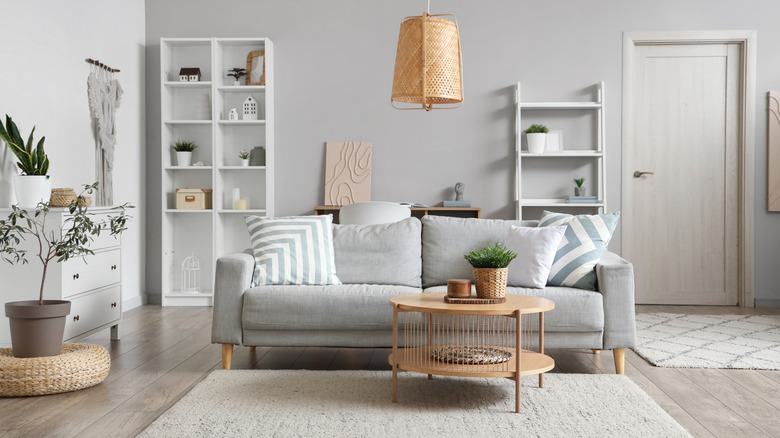 two white shelves in a living room with decor on them