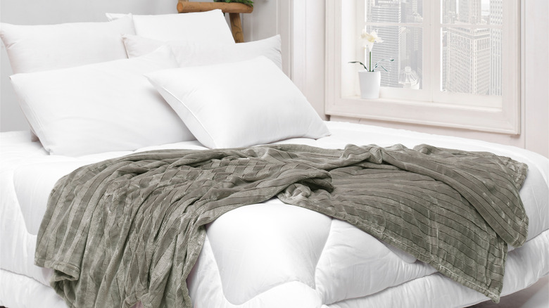 white bedding with gray blanket