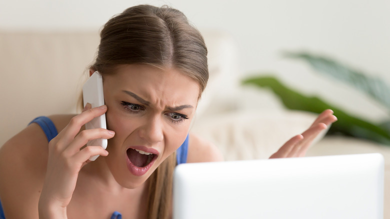 Angry woman yelling into phone