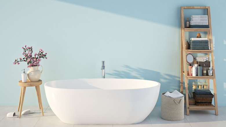 blue wall with white bathtub