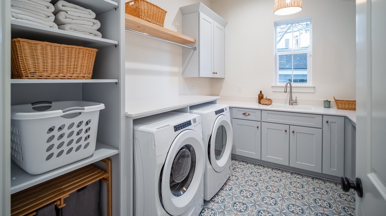 custom laundry room with sink and shelves