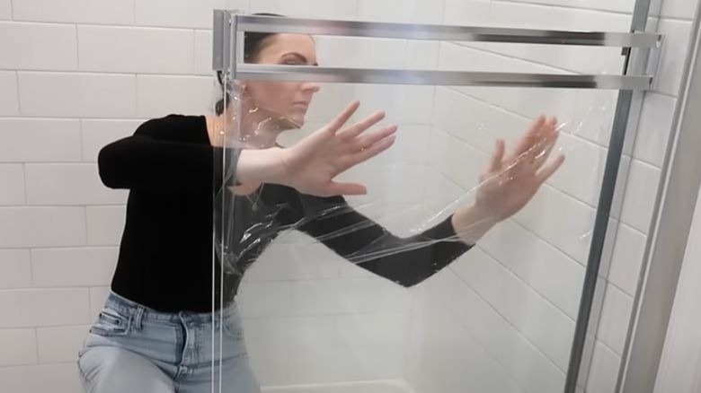 woman cleaning shower door